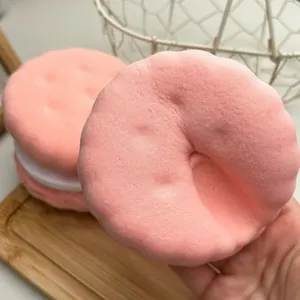 Close-up detail of a pink sandwich cookie squishy toy showing its soft slow-rebound texture