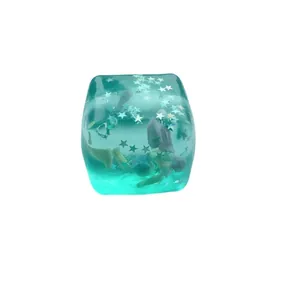 Turquoise cube squishy toy with star glitters and island theme for stress relief