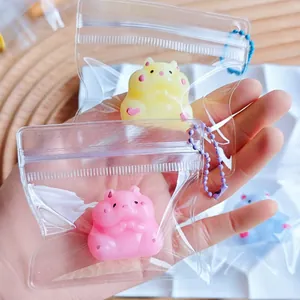 Hand showing colorful mini hamster squishy toys inside mini transparent zip bags