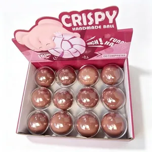 Anzeige von 12 braunen, handgemachten Knusperbällen zum Stressabbau in einer rosa Box.