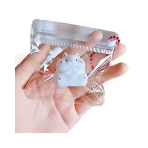 Adorable mini white hamster squishy stress relief toy in a clear bag with red ball chain