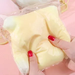 Close-up showing the soft texture of a giant squishy cheese stress relief toy