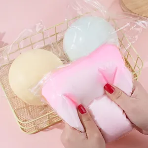 Close-up detail showing the soft and squishy texture of a large pink cheese ball toy
