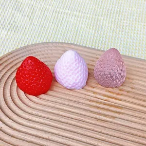 Close-up of strawberry squishy toys with realistic silicone textures and colors