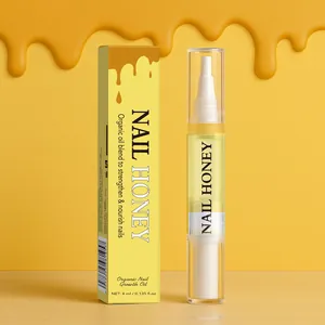 Macro detail view of organic nail honey growth oil pen and yellow packaging box.