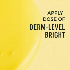 Close-up macro view of concentrated yellow Vitamin C serum texture with brightening droplets