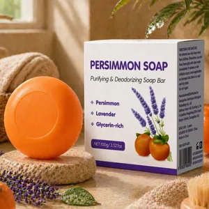 Gros plan d'un pain de savon à la persimmon de 100g et sa boîte de présentation