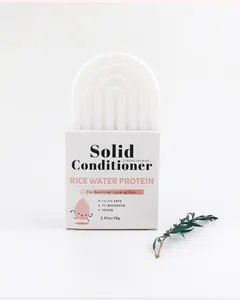 Detail showing a white arched rice water protein solid conditioner bar in its box
