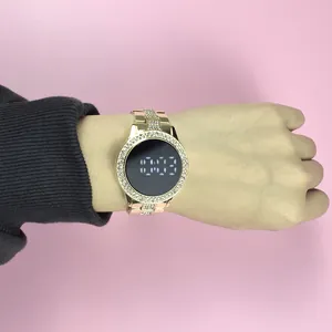 Macro detail view of a stylish gold rhinestone LED ladies watch worn on the wrist