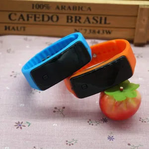 Close-up of vibrant blue and orange silicone LED digital sports watches on a desk