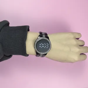 Detail shot of a stylish black LED watch with rhinestones worn on a female wrist.