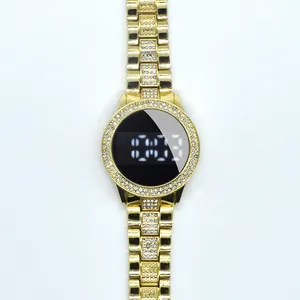 Close-up of a golden women's LED digital watch featuring sparkling rhinestones on the bezel