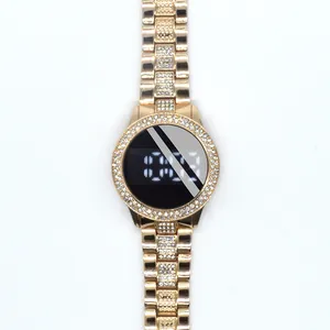 Detailed view of women's gold-tone LED watch with rhinestone bezel and steel link strap