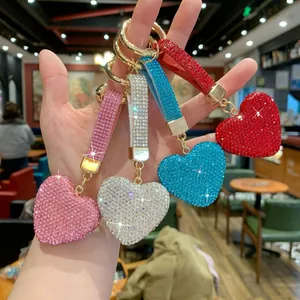 Close-up of sparkling rhinestone heart keychains in pink, silver, blue, and red colors