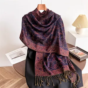 Elegant navy and red paisley pashmina shawl with tassels on a hanger