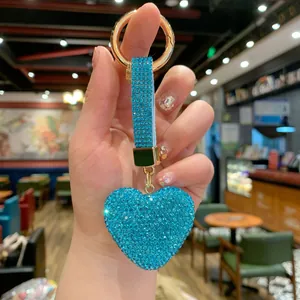 Detailed view of a sparkling blue rhinestone heart keychain for handbag charm.