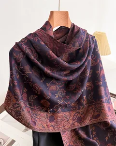 Detail of an elegant paisley pattern faux cashmere scarf in deep purple tones.