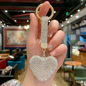 Detailed view of a sparkling rhinestone heart keychain with a shimmering crystal strap