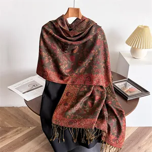 Detailed view of long paisley print scarf with elegant fringe and cashmere-like texture