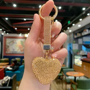 Detailed view of a sparkling gold heart-shaped keychain fully encrusted with rhinestones