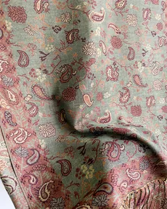 Close-up of elegant paisley pattern on soft faux cashmere pashmina scarf with tassels.