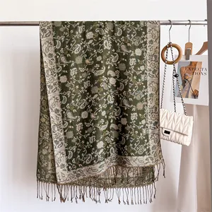 Close-up view of elegant paisley patterns and delicate fringes on a warm faux cashmere scarf