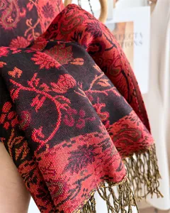 Close-up of red and black paisley pattern scarf with elegant fringe details