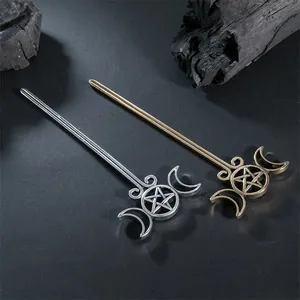 Detailed view of vintage silver and bronze moon pentagram hair sticks with metallic texture.