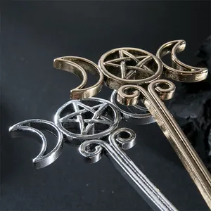 Close-up of vintage alloy hair stick with hollow pentagram and crescent moon design