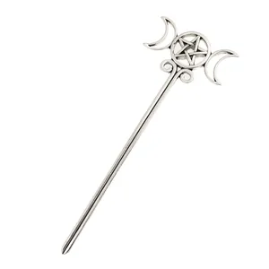 Detailed macro view of silver-tone vintage alloy hair stick with moon and pentagram motifs