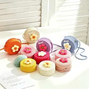 Hand-woven round straw bags for girls in various pastel colors with flower decor.