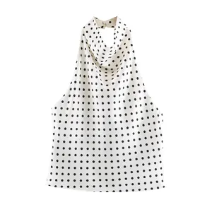 Detailed view of a elegant white satin halter neck top with classic black polka dots