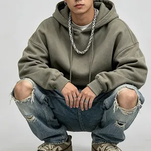 Macro view of a heavy silver stainless steel twist chain necklace worn by male model