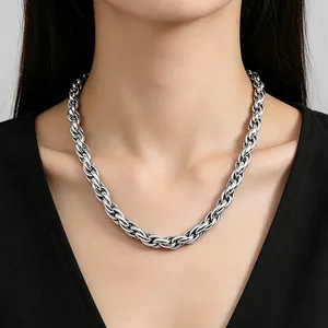 Close-up detail shot of a chunky stainless steel twist chain necklace on an Asian model.