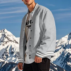 Close-up of grey men's varsity jacket featuring snap buttons and white striped cuffs