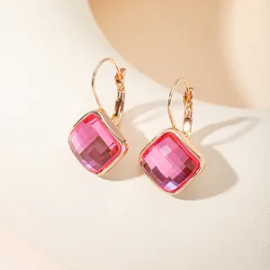 Gros plan détaillé de boucles d'oreilles carrées en zircon rose et crochets dorés