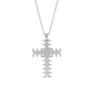 Elegant silver-colored cross necklace with sparkling white zircons on a white background.