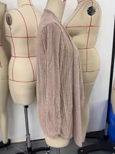 Side view of a ribbed knit beige cardigan on a professional workshop dress form.