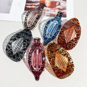 Macro view of stylish leopard print curved hair claw clips in a variety of vibrant colors