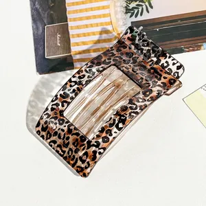 Detailed macro shot of a stylish leopard print curved hair claw clip for women