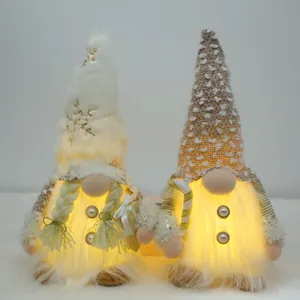 Detailed view of two sequined plush Christmas gnomes with warm LED lights inside