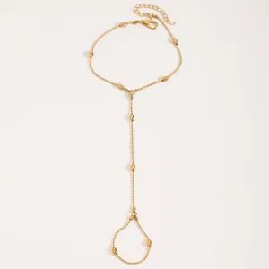 Elegant gold-tone finger bracelet featuring water drop beads on a white background.