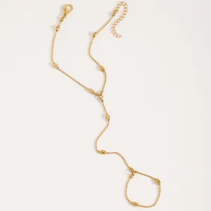 Elegant gold beaded finger chain bracelet with teardrop accents and adjustable clasp