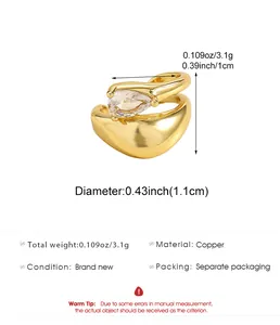 Gold twisted ear cuff with teardrop zircon showing dimensions and copper material.