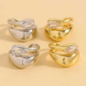 Detailed view of gold and silver water drop zircon ear cuffs with twisted line design