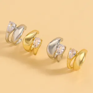 Detailed view of twisted line ear clips with water drop zircons in gold and silver