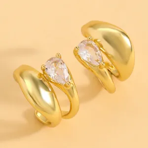 Detail view of gold twisted ear clips featuring water-drop cubic zirconia stones