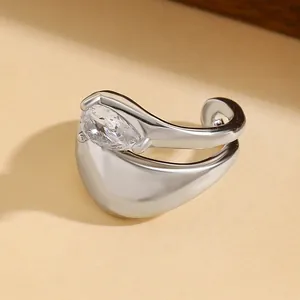 Macro detail of silver twisted ear cuff with a sparkling teardrop cubic zirconia