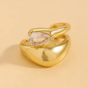 Close-up detail of gold twisted line ear cuff featuring a sparkling teardrop zircon stone