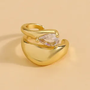 Close-up of an elegant gold ear cuff featuring a sparkling teardrop-shaped zircon.